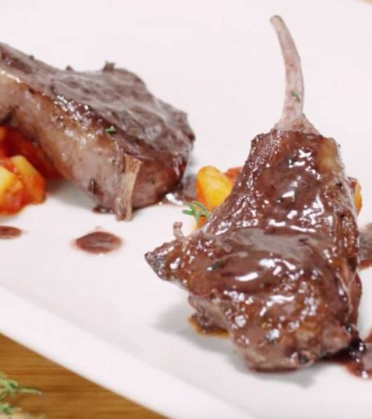 Lamb ribs on steamed potatoes with tomato