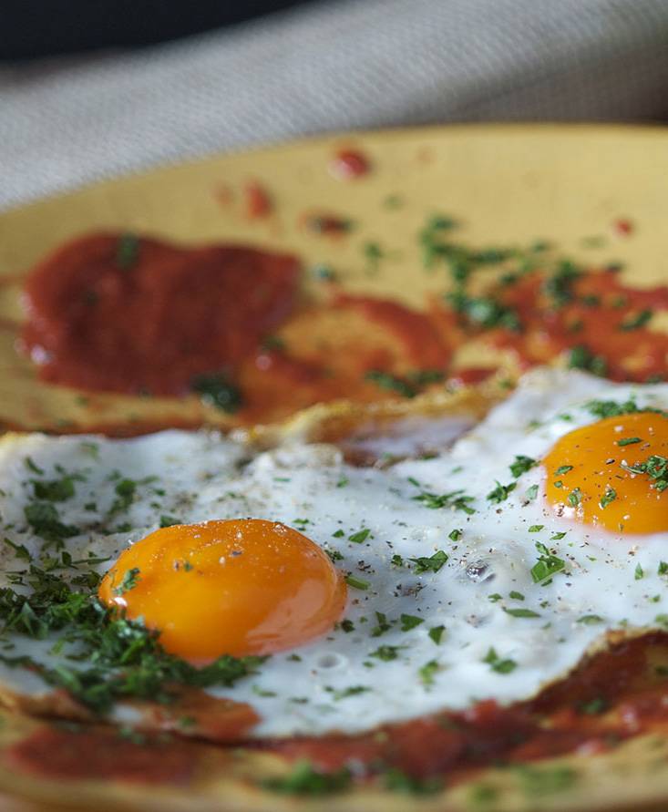 Fried egg sunny side up with tomato
